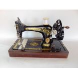 A 19th century cased cast iron Singer sewing machine.