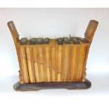 An interesting far eastern glockenspiel type instrument with a bamboo frame upon a stepped plinth