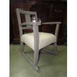 Child's rocking chair with painted finish and upholstered seat.