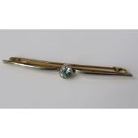 A white and yellow gold bar brooch, set with round cut aquamarine, 2.5g