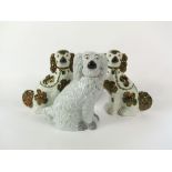 A pair of 19th century Staffordshire spaniels with copper lustre patches, 33cm tall, together with a