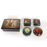 A collection of Russian lacquer boxes, the largest decorated with bears together with figures,