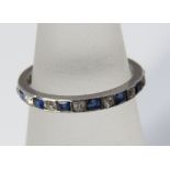 A sapphire and diamond eternity ring in white metal, size K, 2g