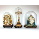 Three Catholic religious dioramas, all under glass domes upon wooden plinth bases (3).