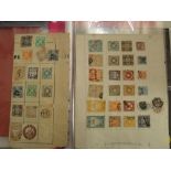 A folder containing old time pages and stock cards of early stamps from Japan