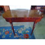 A Georgian mahogany D end fold over top tea table raised on spiral twist support.