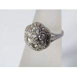 A diamond cluster flower head ring with indistinct marks to shank, size K, 4.5g