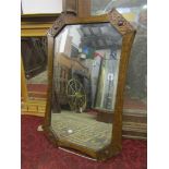 An Edwardian oak wall mirror, the frame with concave borders and applied mouldings together with a