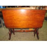 A Victorian walnut sutherland tea table of usual form raised on turned and fluted supports and feet