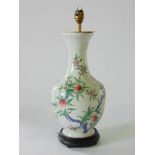 A Chinese porcelain baluster vase converted to a lamp, decorated with pomegranates upon a white