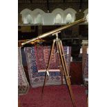 A contemporary brass telescope upon a telescopic tripod base.