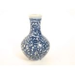 An oriental type blue and white vase with all over floral decoration and blue character mark to