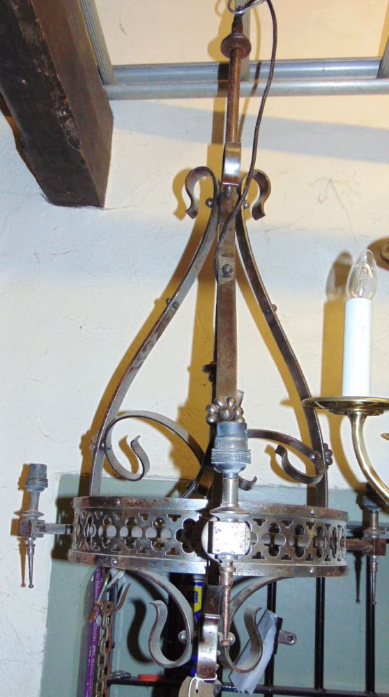 Ecclesiastical style wrought iron hall lantern, with three spoke lights framing a pierced circular