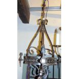 Ecclesiastical style wrought iron hall lantern, with three spoke lights framing a pierced circular