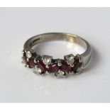 A 9ct white gold ladies ruby and diamond dress ring 6 marquise cut rubies flanked by 9 single cut