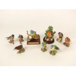 A collection of Beswick models of birds including two chaffinches, two blue tits, a robin, a