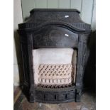 A reclaimed cast iron gas fire with decorative Neo-Classical relief detail; together with an iron