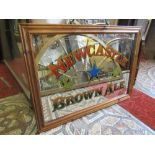 A pub mirror advertising Newcastle Brown Ale set within a moulded pine frame