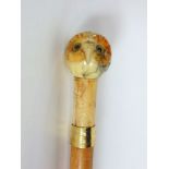 A walking stick with carved hardstone owl head knop and bone collar.