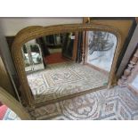 A Victorian gilt framed overmantle mirror of arched form with moulded detail 130cm wide approx