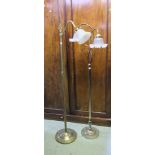 Two brass lamp standards in Edwardian style with etched glass shades.
