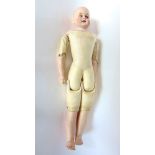 A 19th century continental porcelain headed doll with leather torso, wooden limbs, closing eyes