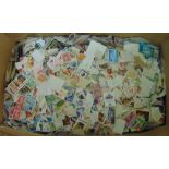 A box containing a large quantity of mixed loose stamps possibly many thousands