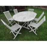 A teak D end extending garden table, the slatted top raise on square cut supports and sledge feet,