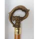 An interesting carved walking stick, the shaft decorated with a snake chasing a frog and arched
