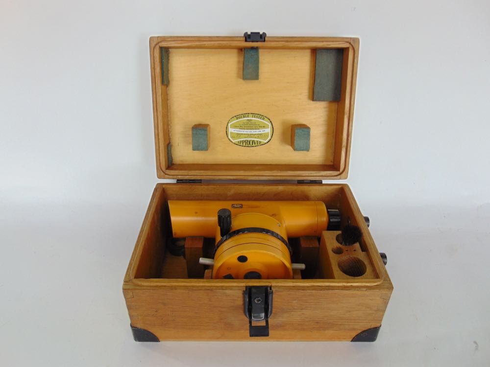 A Carl Zeiss theodolite, the scope in a branded wooden case upon an orange and galvanised steel