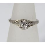 A solitaire diamond ring, marked 14k, in pierced floral setting, size J/K, 1g