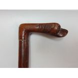 A Crecian walking stick, the handle carved with a dogs head.