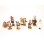 A collection of six Hummel figures of children including musicians, shoe maker, etc together with