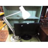 A Flatron M2262D flat screen television with handset together with an angle poise table lamp