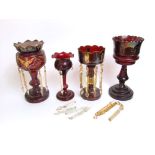 Four various 19th century cranberry glass lustres, part fitted with prismatic drops, the largest