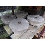 Four small natural stone grinding/mill wheels, slight variant in size, the largest 38 cm, the