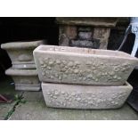 A pair of contemporary but partially weathered cast composition stone garden flower troughs of