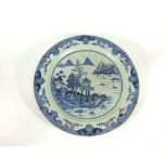 A pair of large 19th century oriental blue and white chargers with painted landscape decoration
