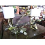 A selection of five contemporary brass table lamps, three with adjustable arms and with a bright