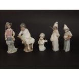 A collection of five Lladro figures of children including a boy fisherman, a girl holding a