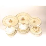 A collection of Susie Cooper dinner wares with spring flower decoration comprising a pair of two