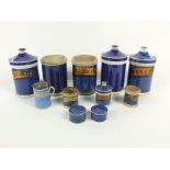 A collection of 19th century blue glazed drugs jars of cylindrical form comprising five large