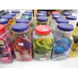 Twenty two plastic sweetie jars containing a large quantity of threads, beads, lace, etc.,