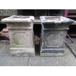 A pair of reclaimed buff coloured chimney pots of squat rectangular and moulded form