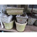 A set of four contemporary but partially weathered cast composition stone garden planters/flower