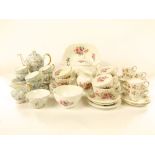 A collection of Coalport floral patterned tea wares comprising tea pot, sugar bowl, milk jug, cake