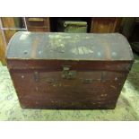 A vintage brown fibre and leather re-inforced domed top travelling chest with brass lock and army