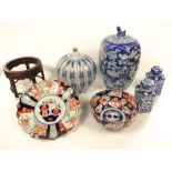 A collection of oriental ceramics including an imari bowl and dish, a pair of tea caddies and covers