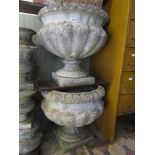 A pair of good quality weathered contemporary cast composition stone garden urns in a Georgian