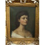 A 20th century oil painting on canvas, bust length portrait of a young woman, signed bottom left